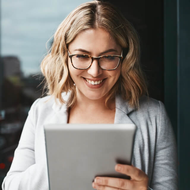 Woman smiling using tablet