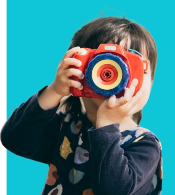 Child with a toy camera